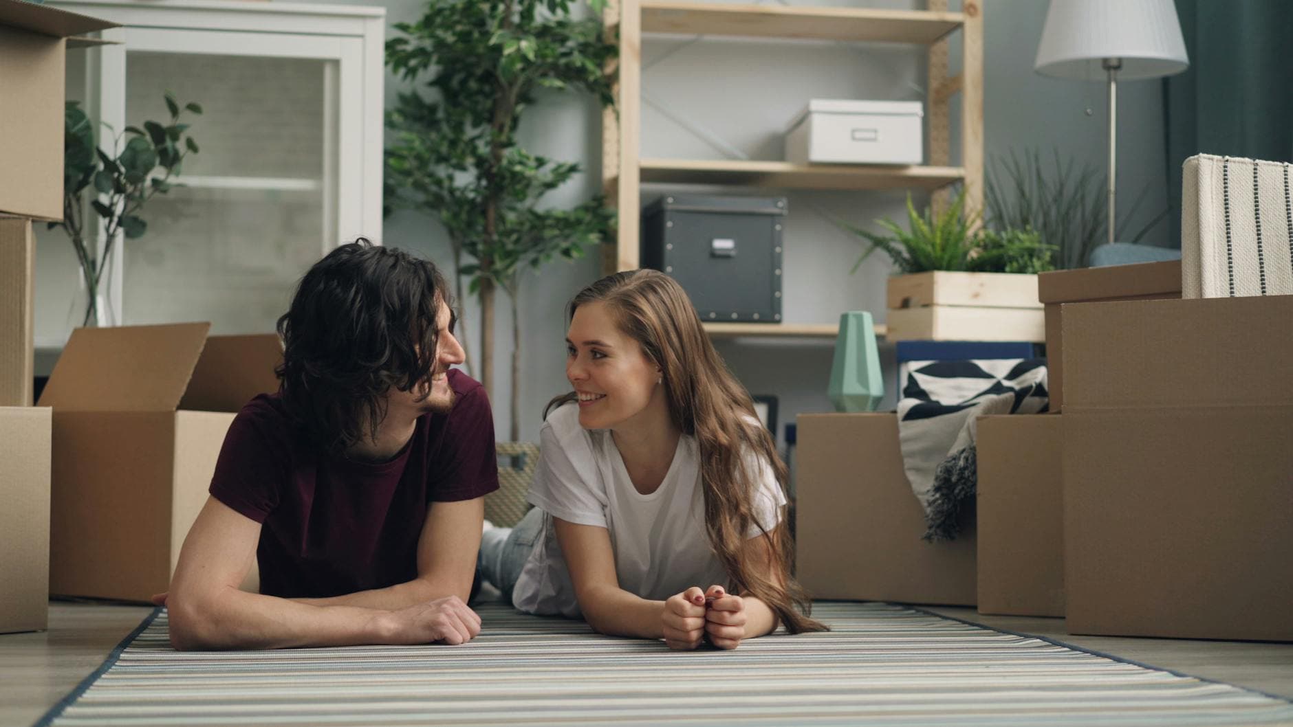 Young couple unwinding in their new home after moving in