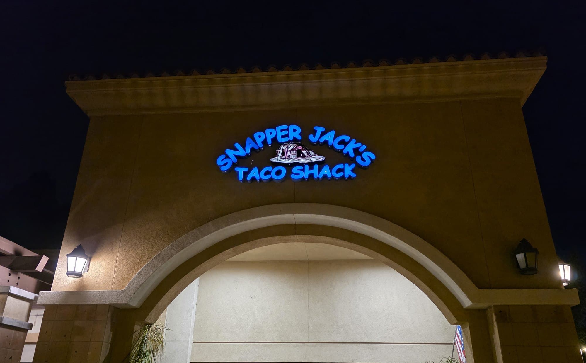 The lit Snapper Jack's Taco Shack sign above the arched entrance of the Camarillo restaurant on Santa Rosa Road at night