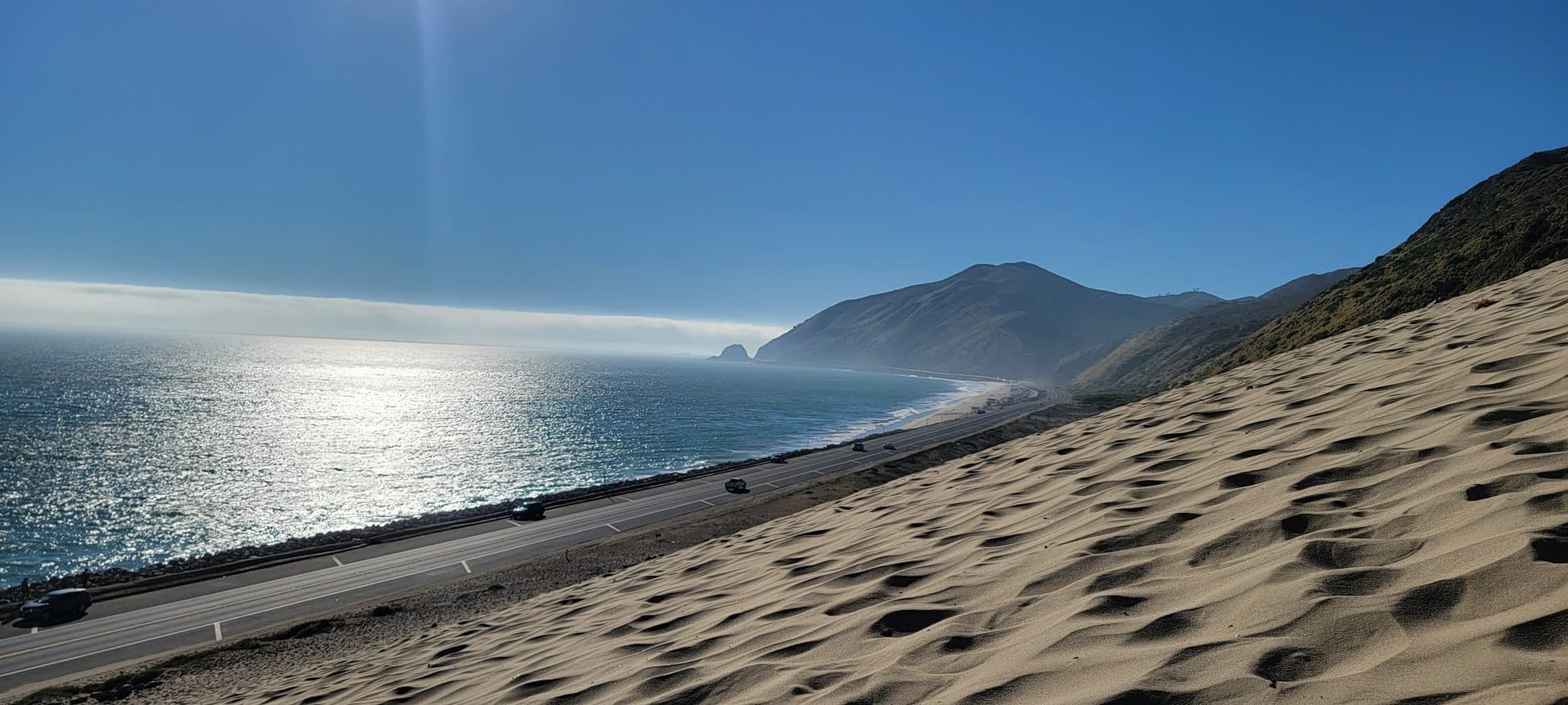 The Point Mugu sand dune above Pacific Coast Highway, with Mugu Rock in the distance